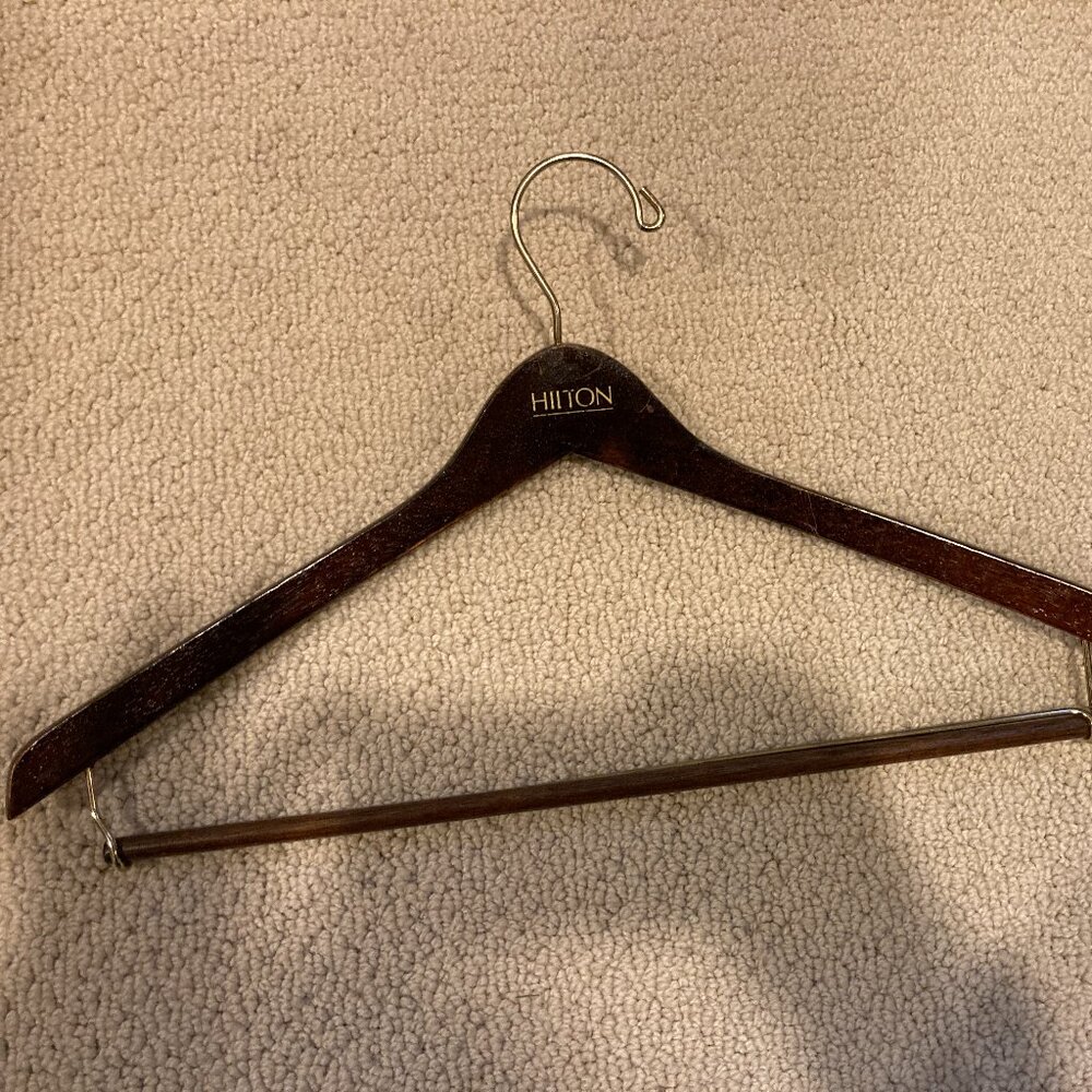 Vintage Hilton dark brown glossy wooden suit hanger.  some scratches.